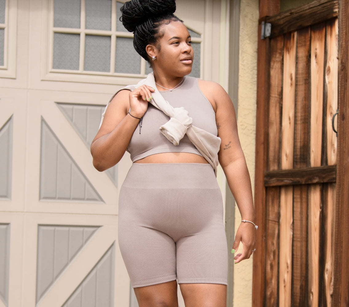 Model wearing the Sublime® Bamboo Maternity & Nursing Longline Bra Top and the Sublime® Bamboo Maternity & Postpartum Bike Short in Taupe.