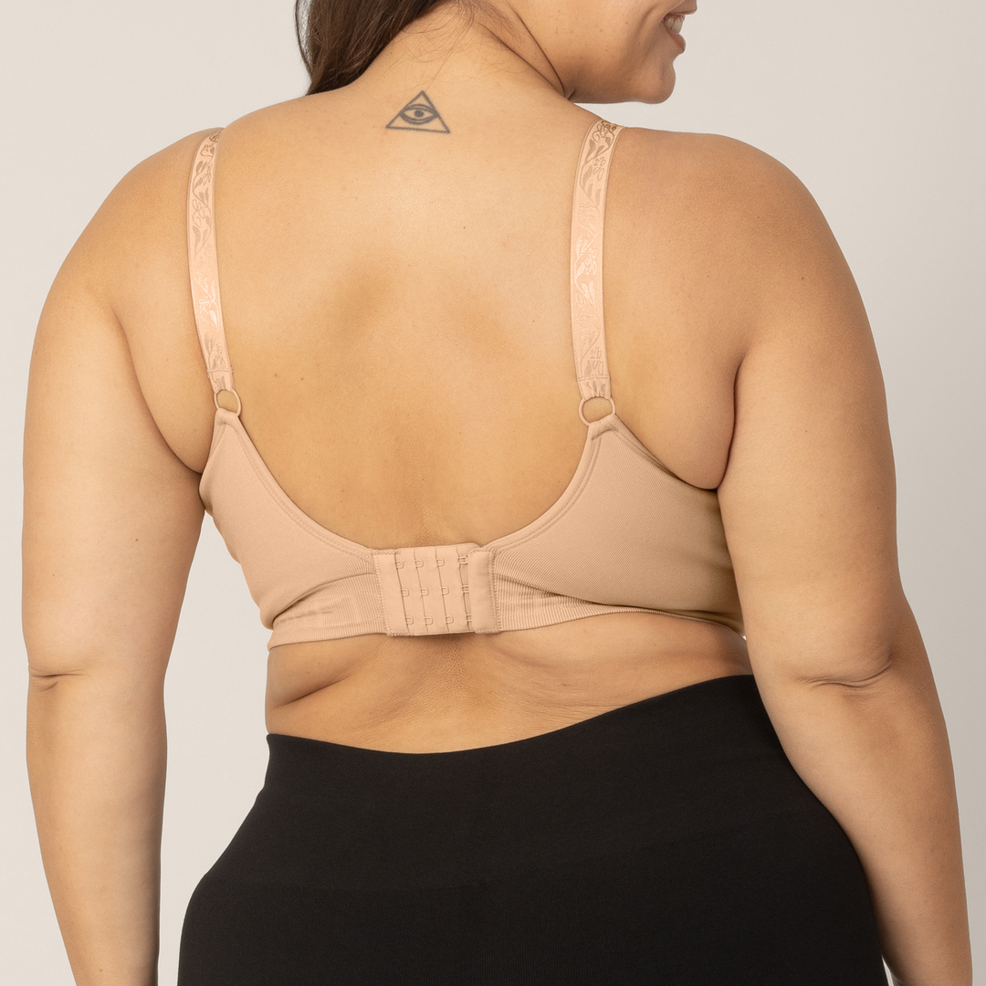 Back view Zoomed in image of super busty model wearing the Sublime Hands-Free Pumping & Nursing Bra in Beige.