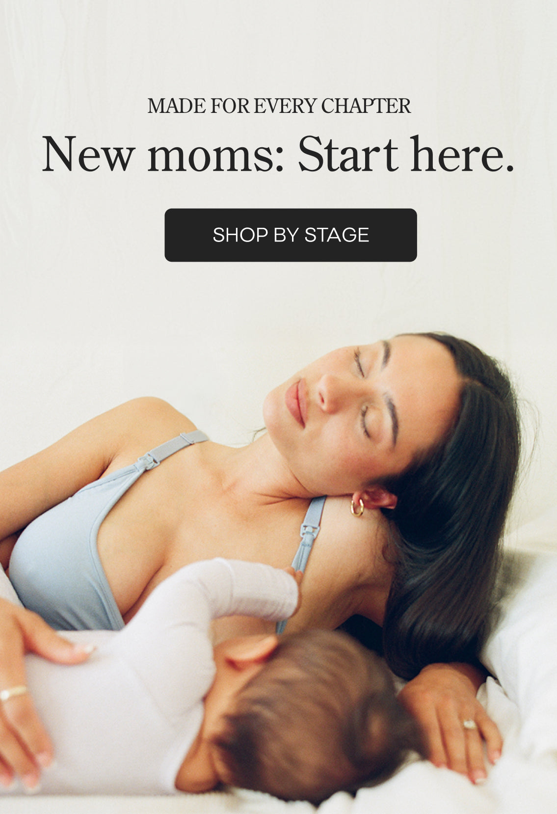 Black text on white background: Made for Every Chapter, New Moms: Start here. Black button with white letters: Shop by Stage. Mother resting on her side while breastfeeding baby and wearing French Terry Maternity & Nursing Bralette in Vintage Blue.