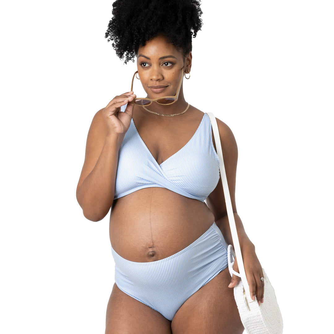 Full body view of a pregnant model wearing the High Rise Maternity & Postpartum Bikini Bottom in Coastal Stripe