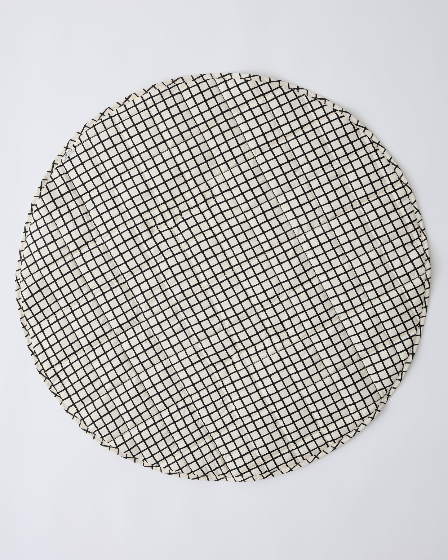 Inside/Outside Play Mat in Black Grid on a beige background.