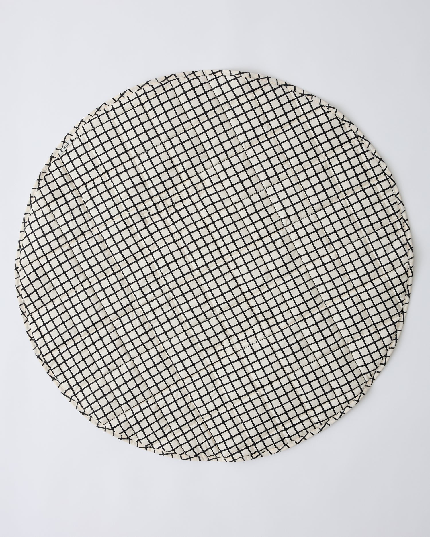 Inside/Outside Play Mat in Black Grid on a beige background.