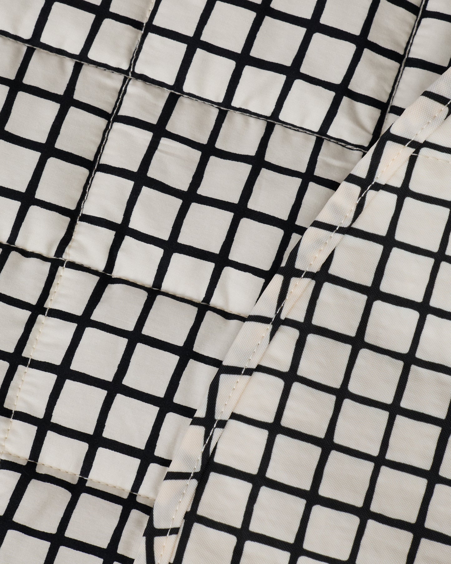 Close up of the pattern on the Inside/Outside Play Mat in Black Grid.