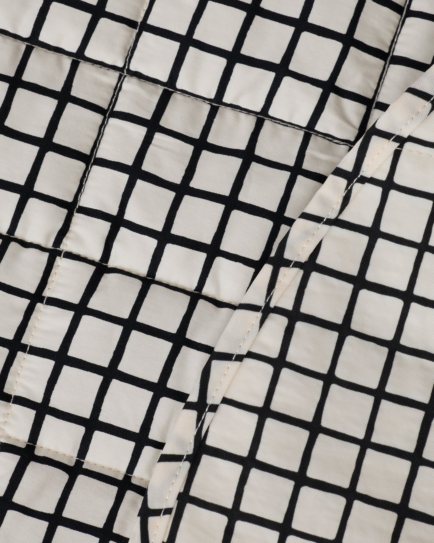 Close up of the pattern on the Inside/Outside Play Mat in Black Grid.