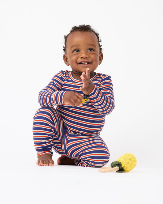 Baby is playing with toy car and wearing wearing Bamboo Baby Two-Piece Pajama Set in Preppy Stripe on a beige background@model_info:Jobadaiah is wearing 12-18 months.