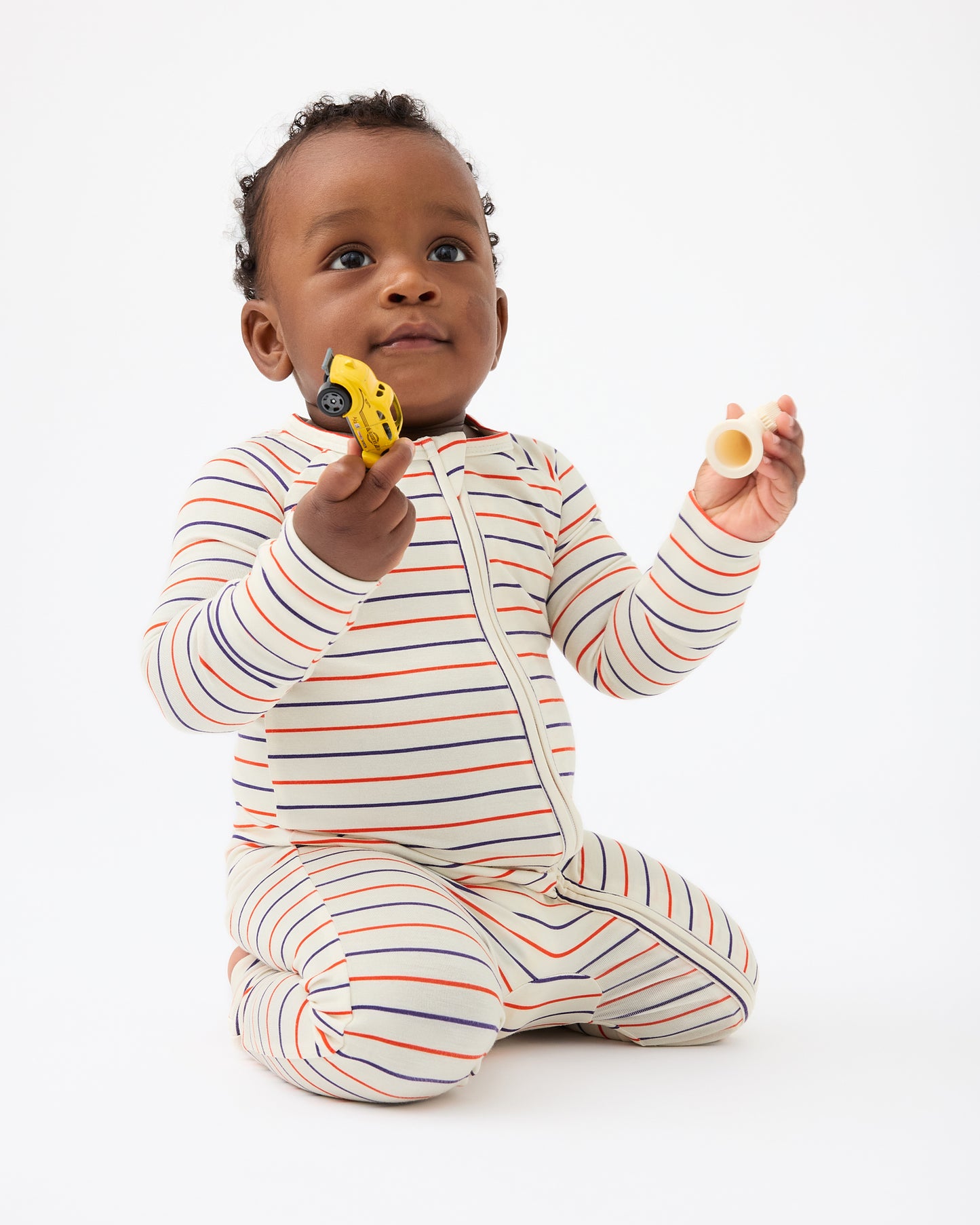 Baby is wearing Bamboo Baby Pajama in Pencil Stripe on a beige background@model_info:Jobadaiah is wearing 6-12 months.