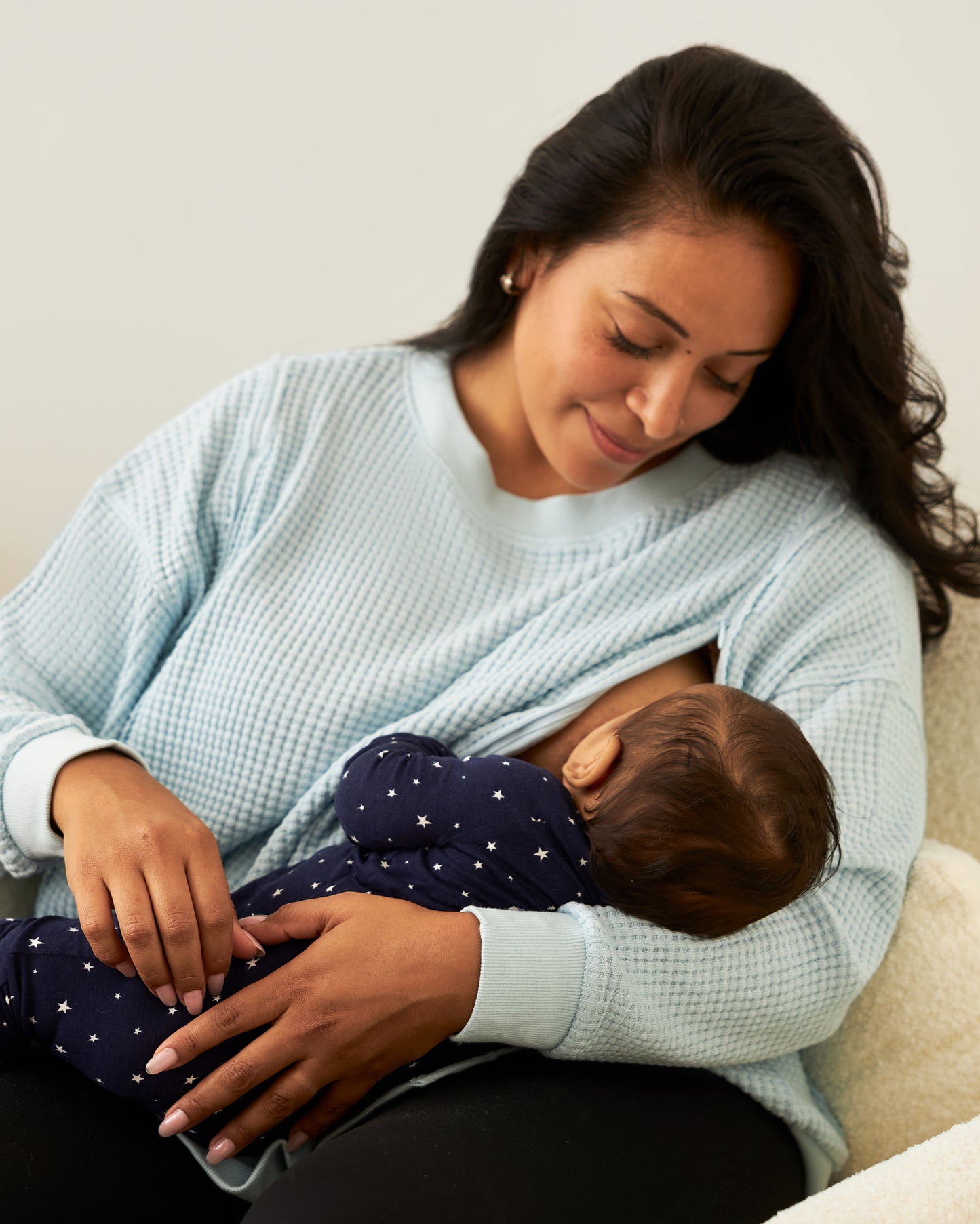 Model nursing baby, wearing Joelle Thermal Maternity & Nursing Top in Powder Blue