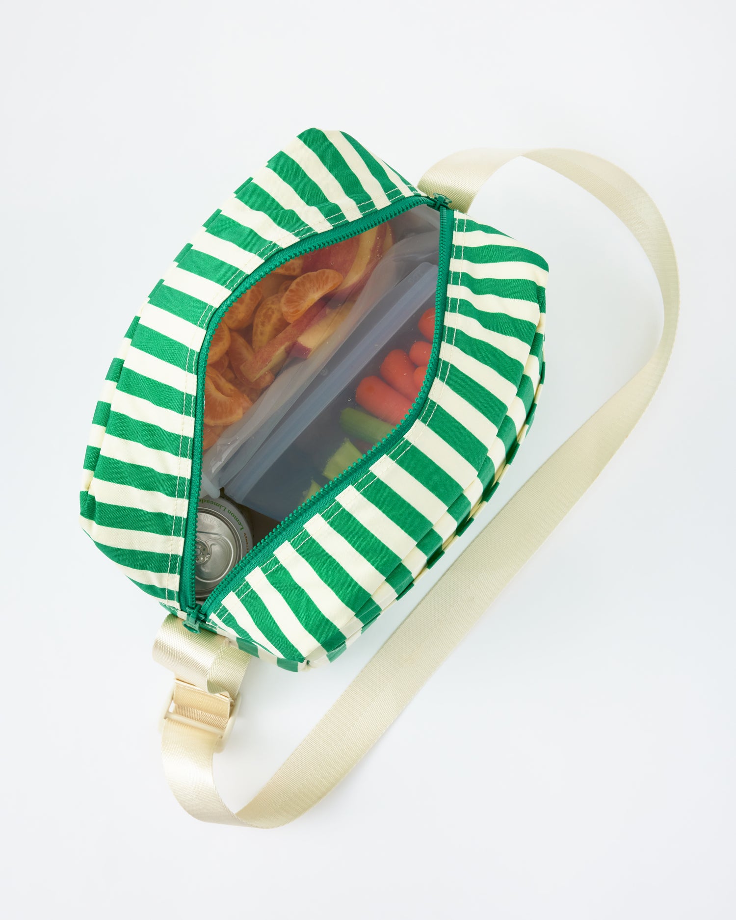 View looking down into Jumbo Cooler Bag in Green Stripe, filled with food and drinks, on a beige background.