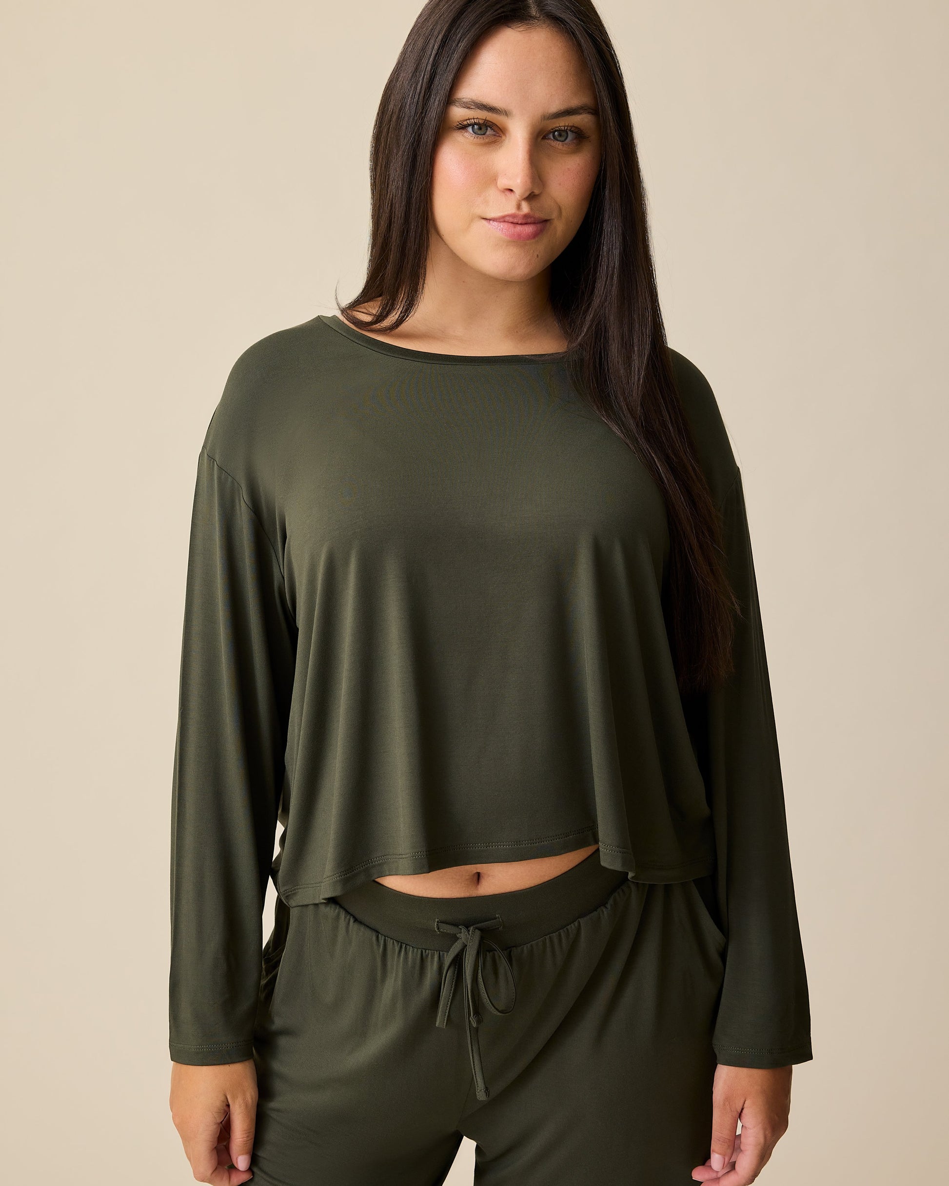 Front view of model wearing Aria Bamboo Casual Cropped Long Sleeve Top in Thyme on a beige background.@model_info:Brianna is wearing a Small.