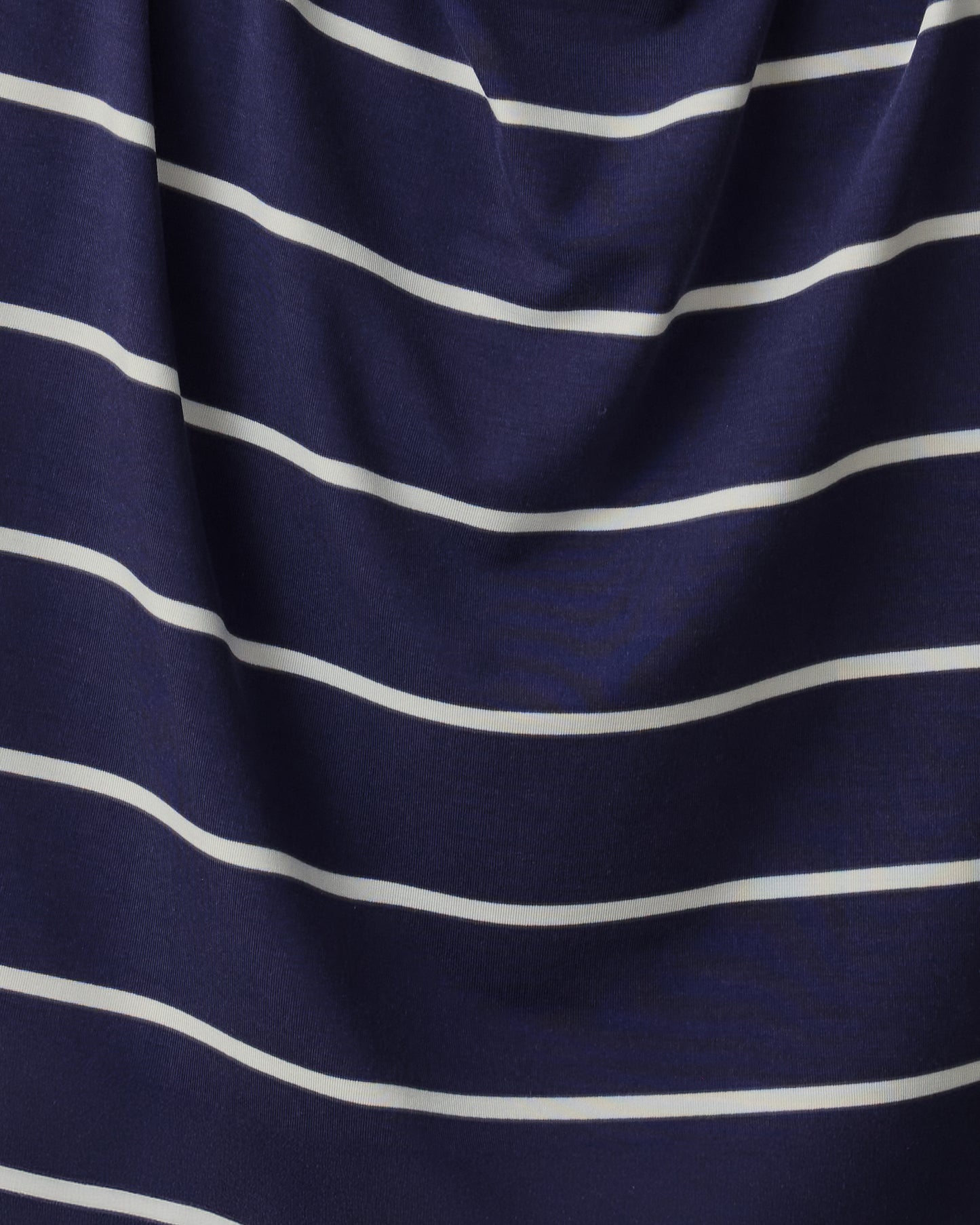 Close up of soft material of Aria Bamboo Cropped V-neck Tank and Aria Bamboo Casual Lounge Short in Navy & White Stripe.