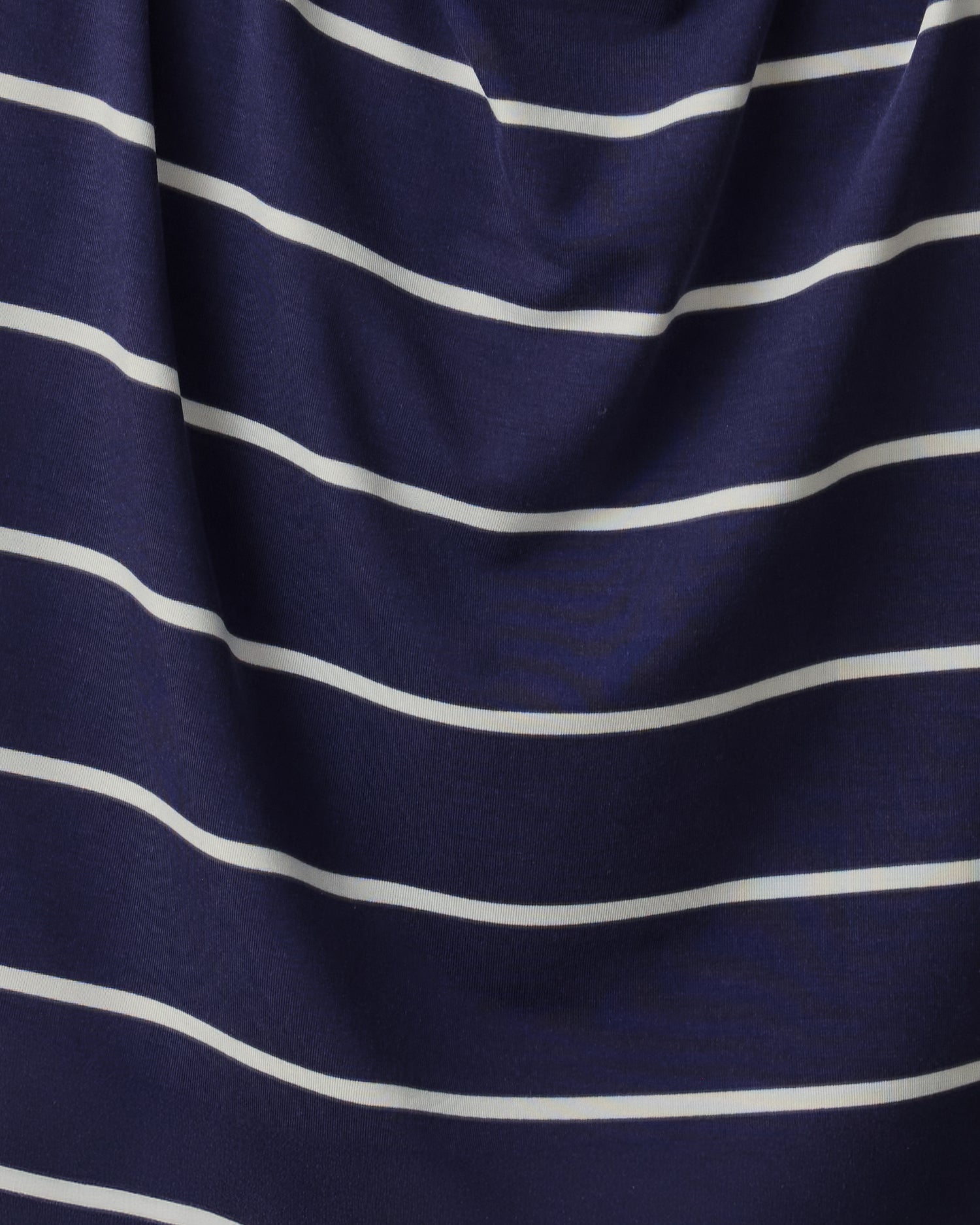 Close up of soft material of Aria Bamboo Cropped V-neck Tank and Aria Bamboo Casual Lounge Short in Navy & White Stripe.