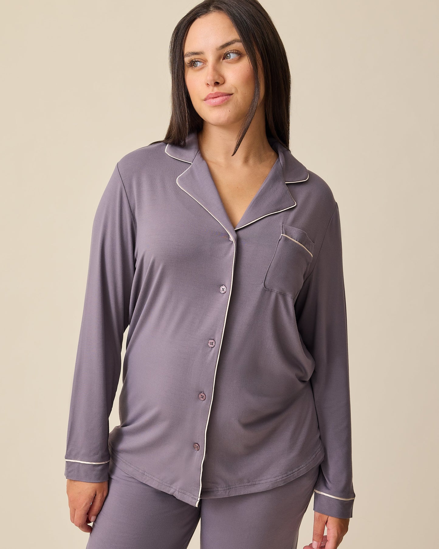 Model is wearing the Clea Bamboo Long Sleeve Pajama Set in Granite on a beige background. 
