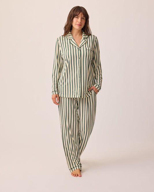 Model is wearing Clea Bamboo Long Sleeve Pajama Set in Green Candy Stripe, on a beige background.@model_info:KJ is 5'9" and wearing a Medium.