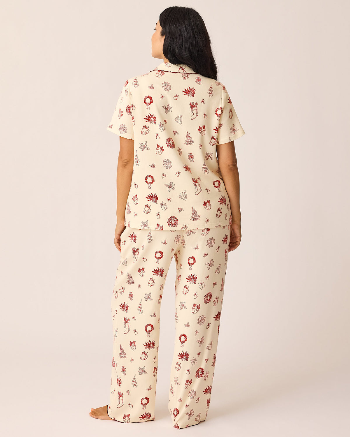 Back view of the model wearing the Cotton Bamboo Pajama Set in Cozy Day pattern on a beige background. 
