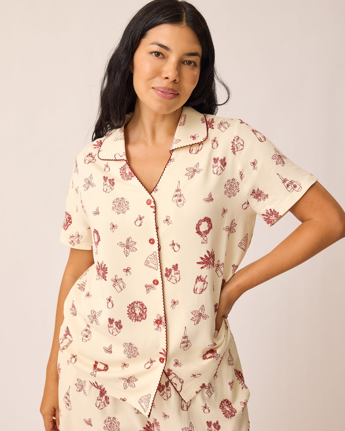 Close up of the model wearing the Cotton Bamboo Pajama Set in Cozy Day pattern on a beige background. 