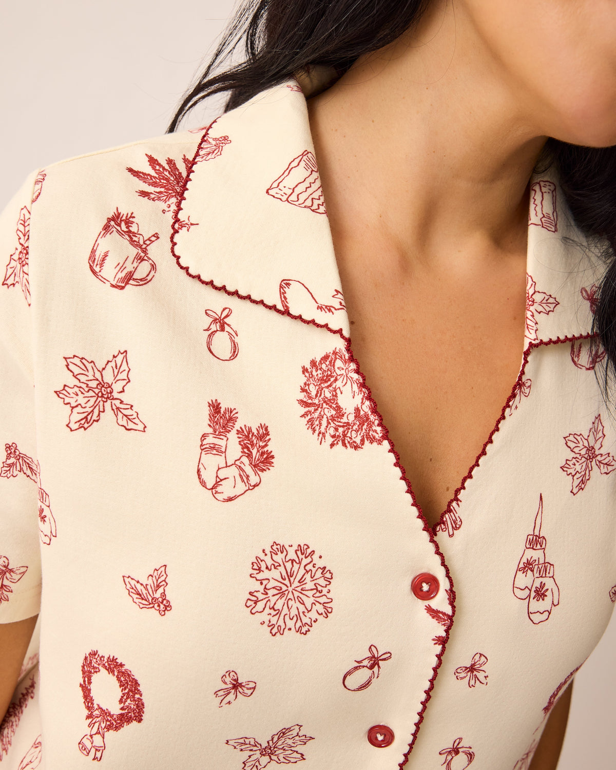 Detail of collar of the Cotton Bamboo Pajama Set in Cozy Day pattern on a beige background. 