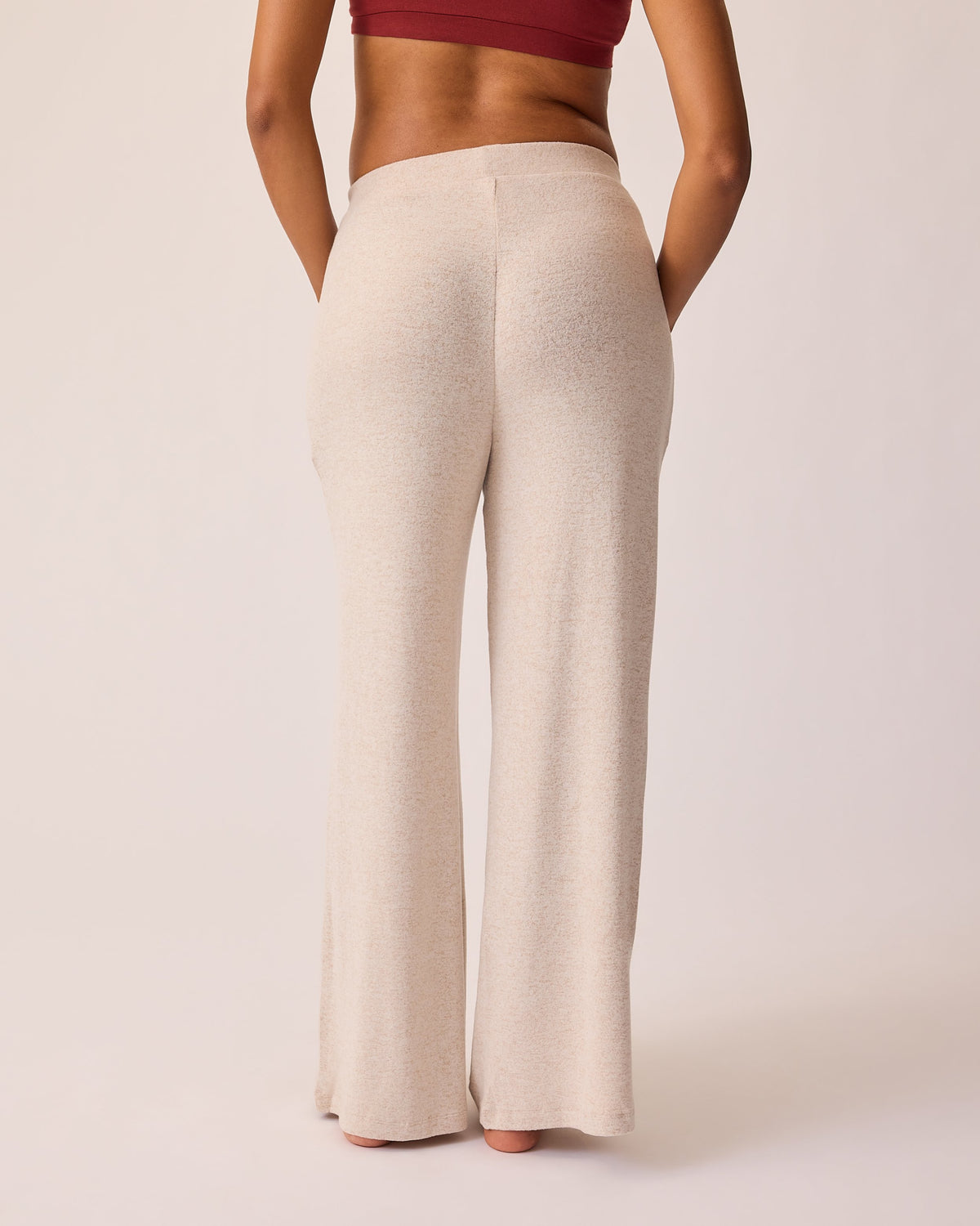 Back view of CozyKnit Wide Leg Lounge Pant in Oat on a beige background.