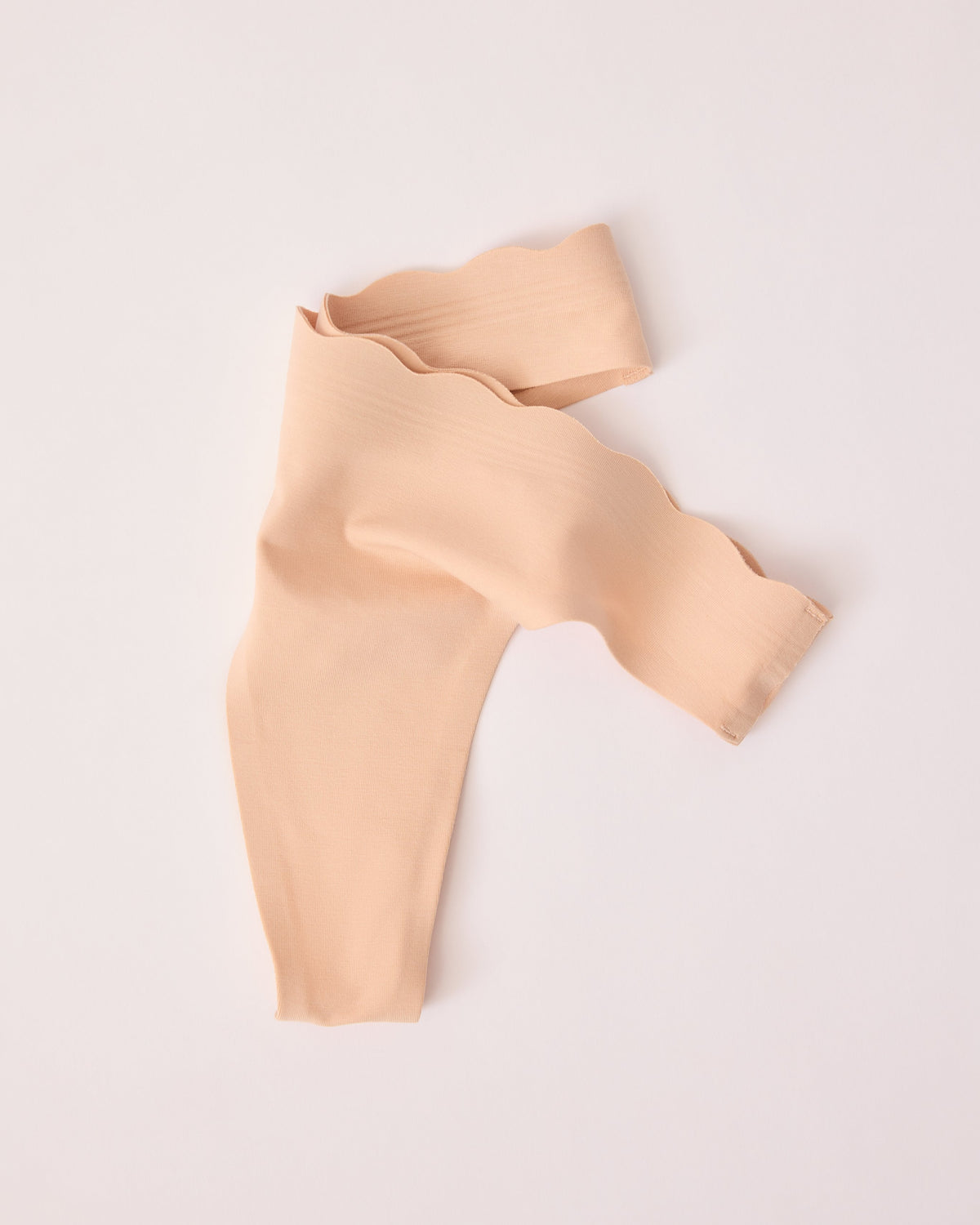 BareBond™ Cotton Maternity & Postpartum Thong in Sand casually placed on a beige background. 
