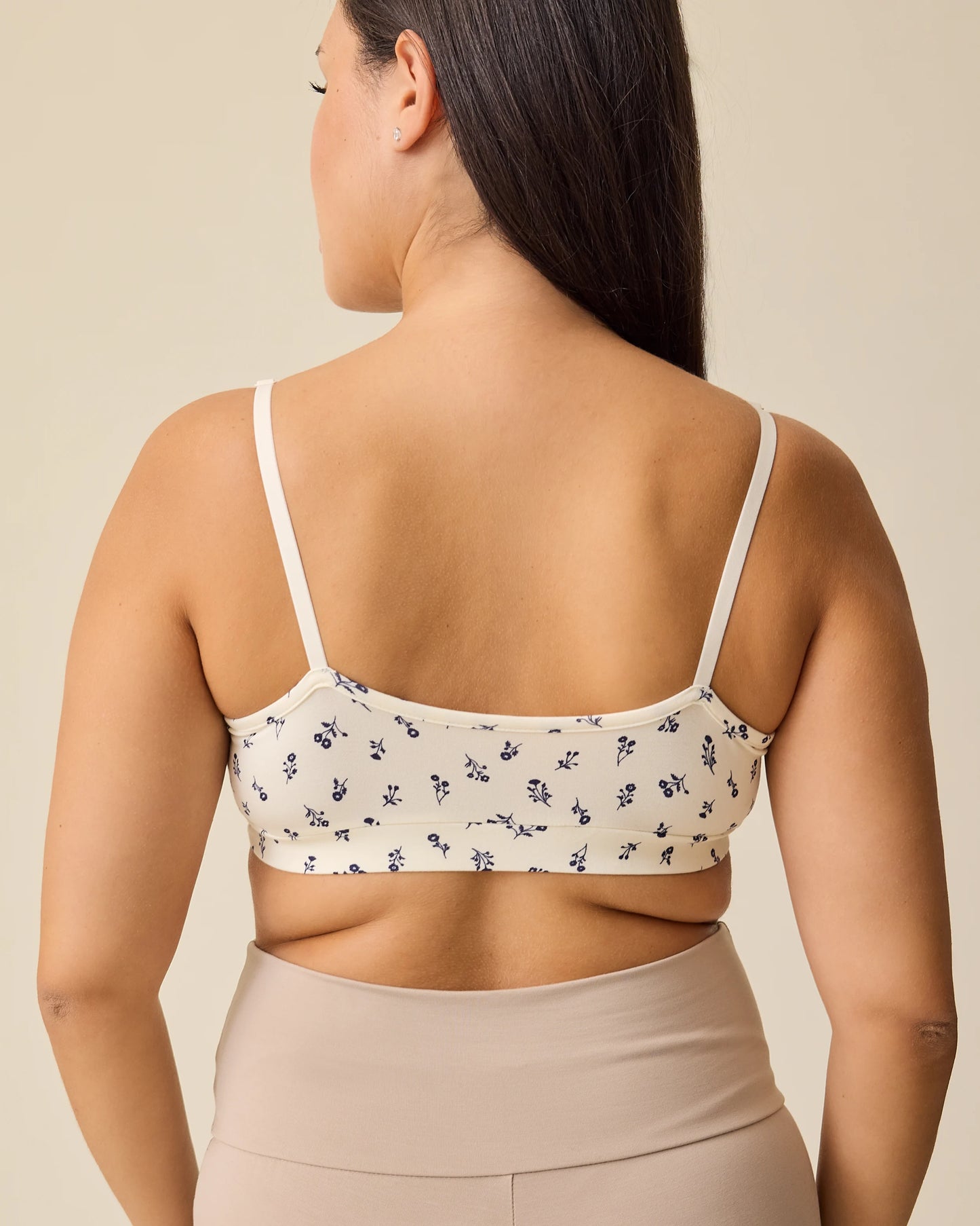 Back view of the French Terry Maternity & Nursing Bralette in Ivory Wildflower on a beige background.