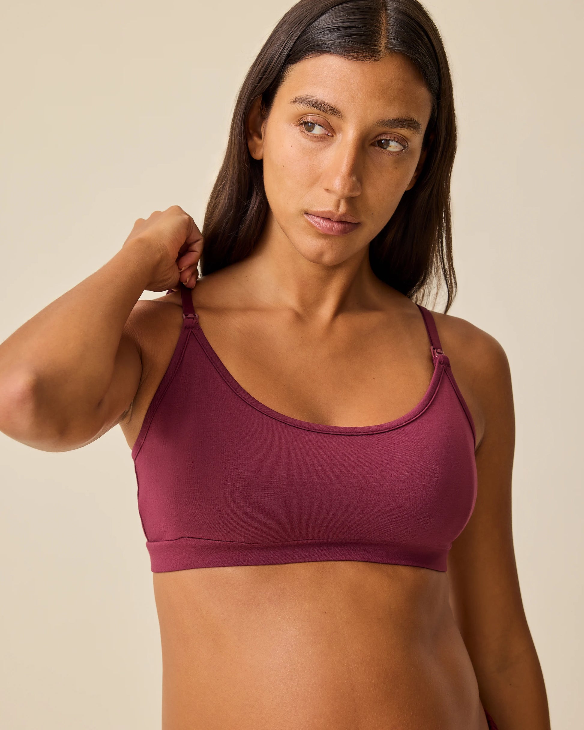 Model is wearing French Terry Maternity & Nursing Bralette in Deep Burgundy on a beige background.