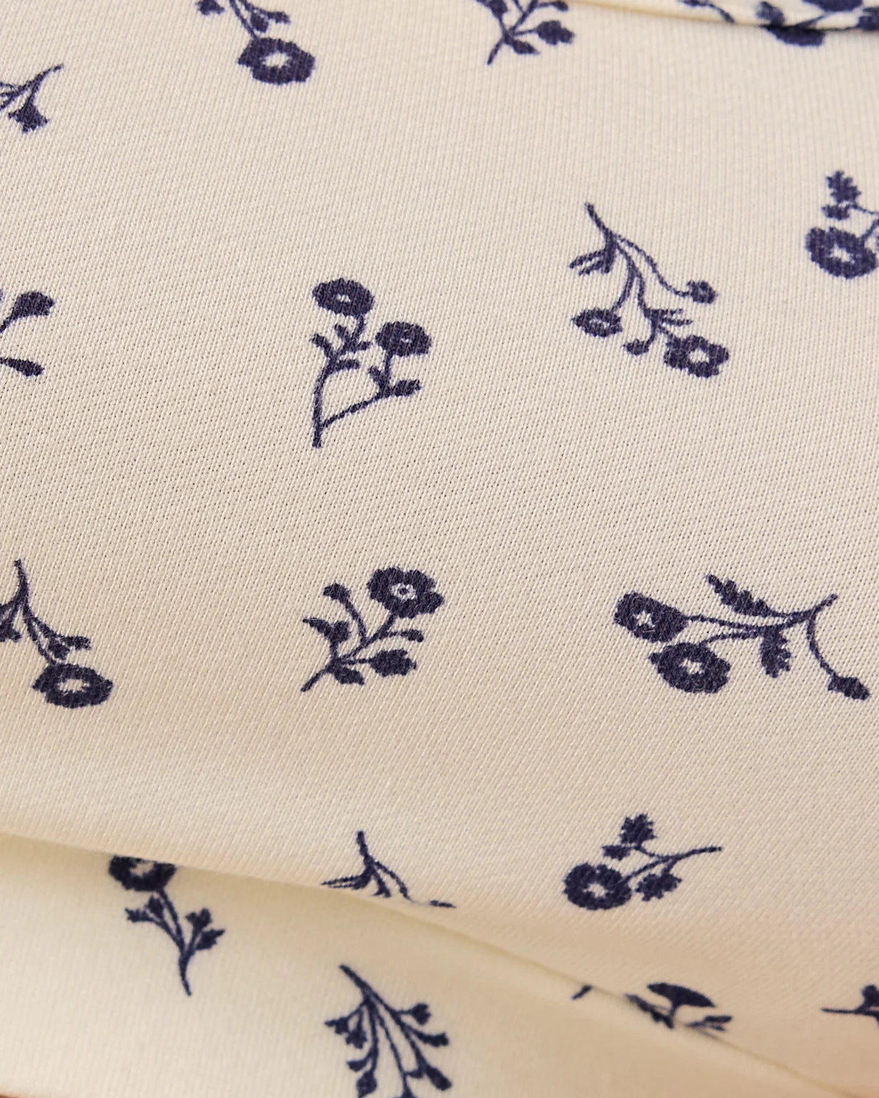Close up of material and pattern on the Model is wearing French Terry Racerback Nursing & Sleep Bra in Ivory Wildflower.