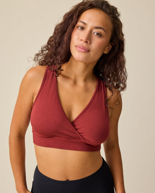 Close up of model wearing French Terry Racerback Nursing & Sleep Bra in Auburn on a beige background. @model_info:Sadie is wearing a Medium.