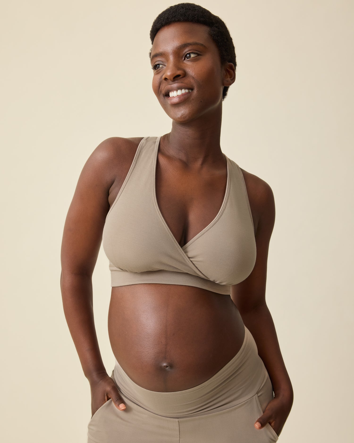 Model is wearing French Terry Racerback Nursing & Sleep Bra in Sandstone on a beige background