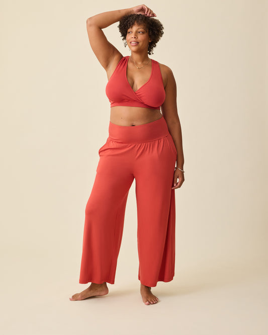 Model is wearing French Terry Racerback Nursing & Sleep Bra in Spice and Bamboo Wide Leg Maternity & Postpartum Lounge Pant in Spice on a beige background. @model_info:Skye is 5'11" and wearing a Long X-Large.