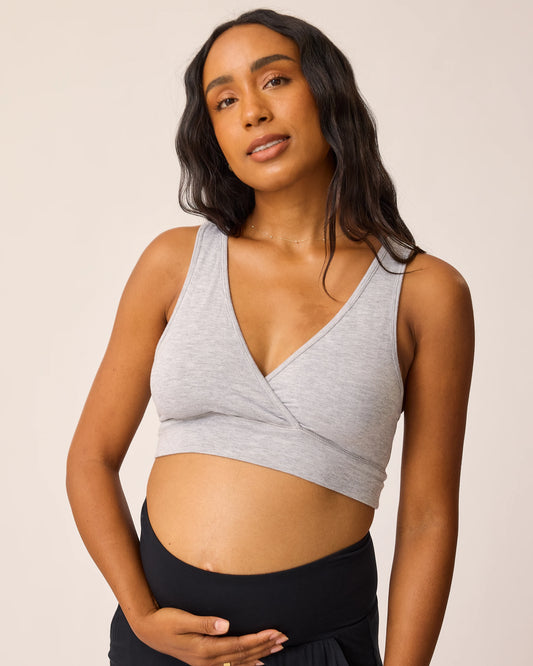Woman wearing the French Terry Racerback Nursing & Sleep Bra in grey heather against a beige background@model_info:Aysia is wearing a Small.