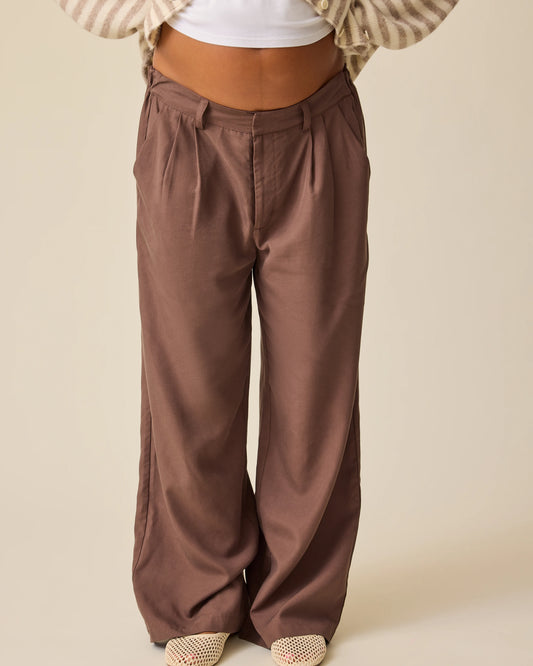 Close up of model wearing Ultra Soft Maternity & Postpartum Cardigan in Tan & White Stripe, Maternity & Postpartum Wide Leg Trouser in Brown and a nursing white tee, on a beige background..@model_info:Hayley is 5'7" and wearing a Small.