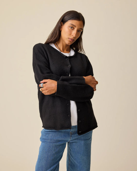 Model is wearing Ultra Soft Maternity & Postpartum Cardigan in Black, Wide Leg Maternity & Postpartum Jean in Medium Wash and a white nursing top, on a beige background.@model_info:Hayley is wearing a Small.
