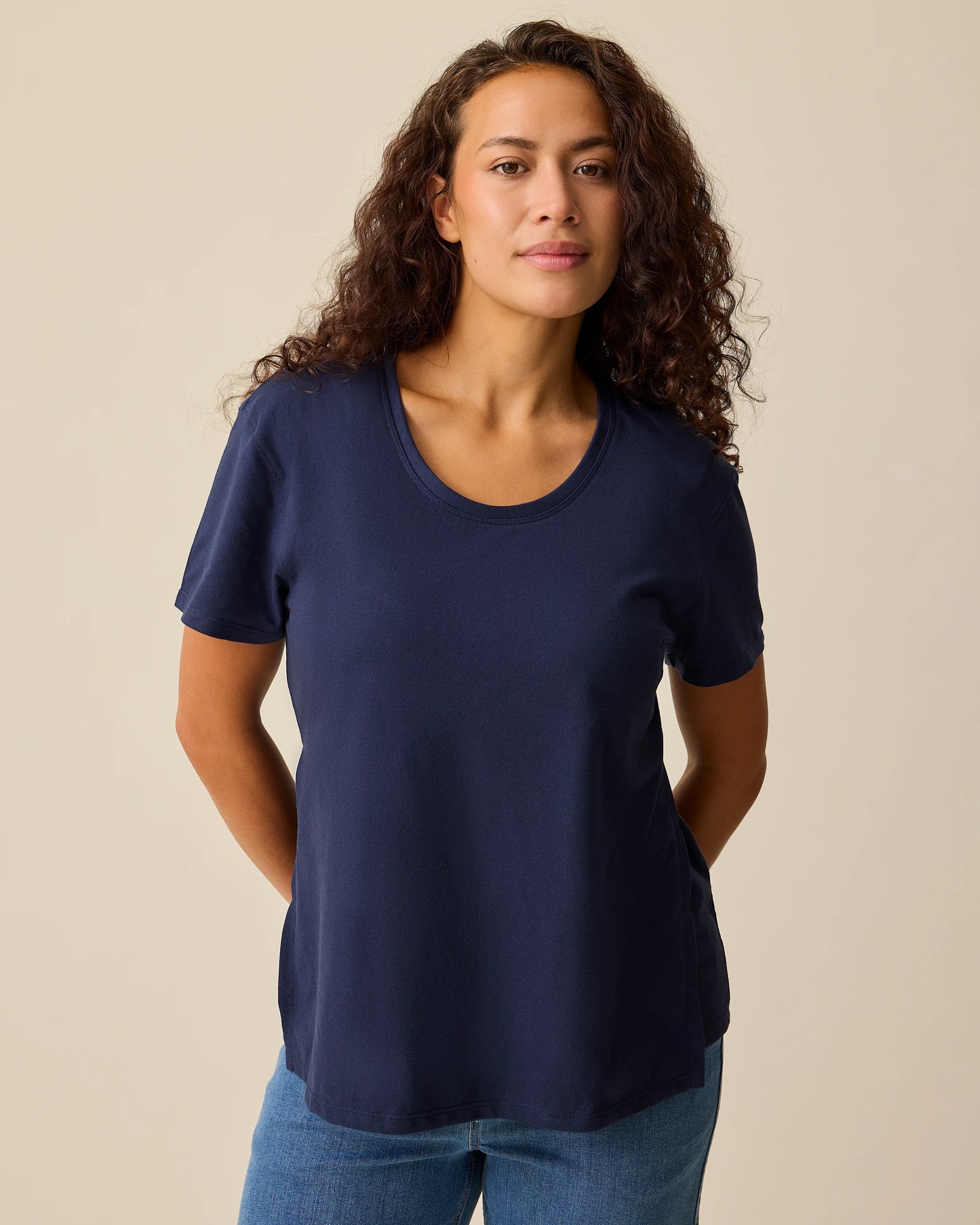 Model is wearing Relaxed Cotton Maternity & Nursing T-shirt in Navy on a beige background. @model_info:Sadie is wearing a Small.