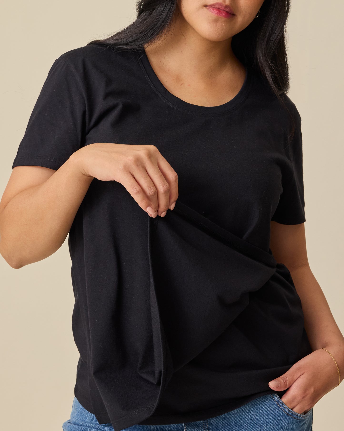 Model showing nursing access on Relaxed Cotton Maternity & Nursing T-shirt in Black on a beige background.