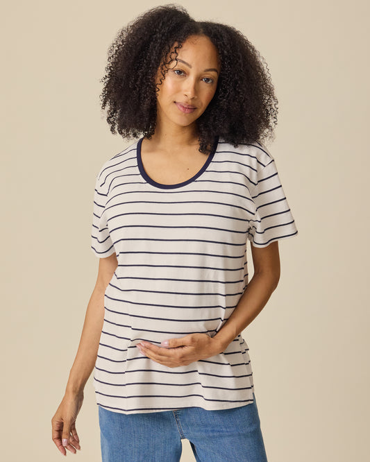 Model is wearing Relaxed Cotton Maternity & Nursing T-shirt in Navy & White Stripe on a beige background. @model_info:Courtney is wearing a Small.