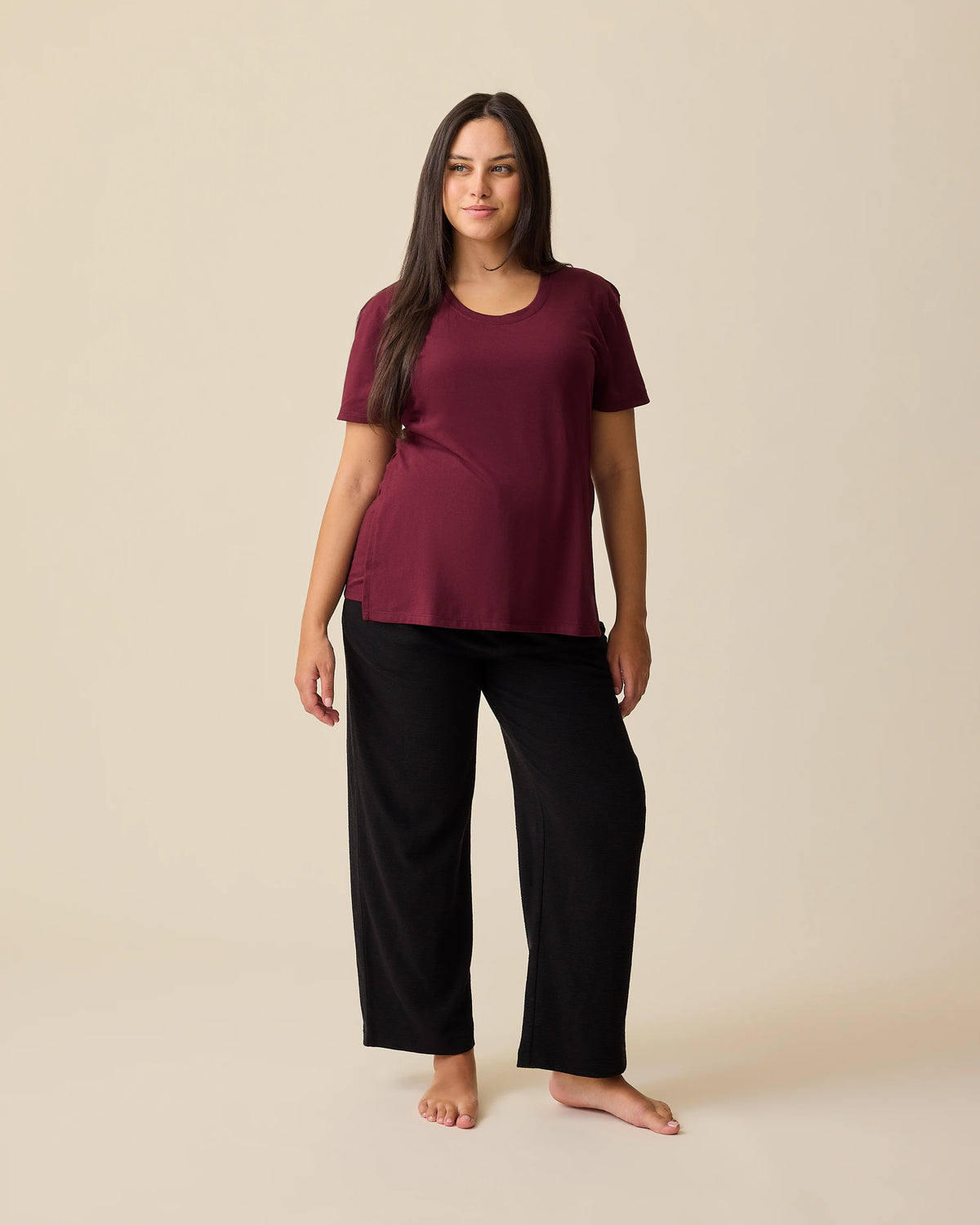 Model is wearing Relaxed Cotton Maternity & Nursing T-shirt in Fig on a beige background. 
