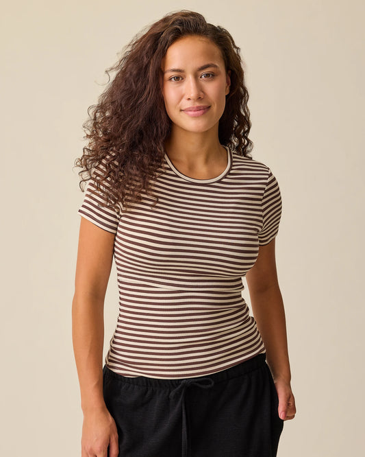 Model is wearing the Ribbed Bamboo Crew Neck Nursing T-shirt in Chocolate & Ivory Stripe on a beige background. @model_info:Sadie is wearing a Medium.