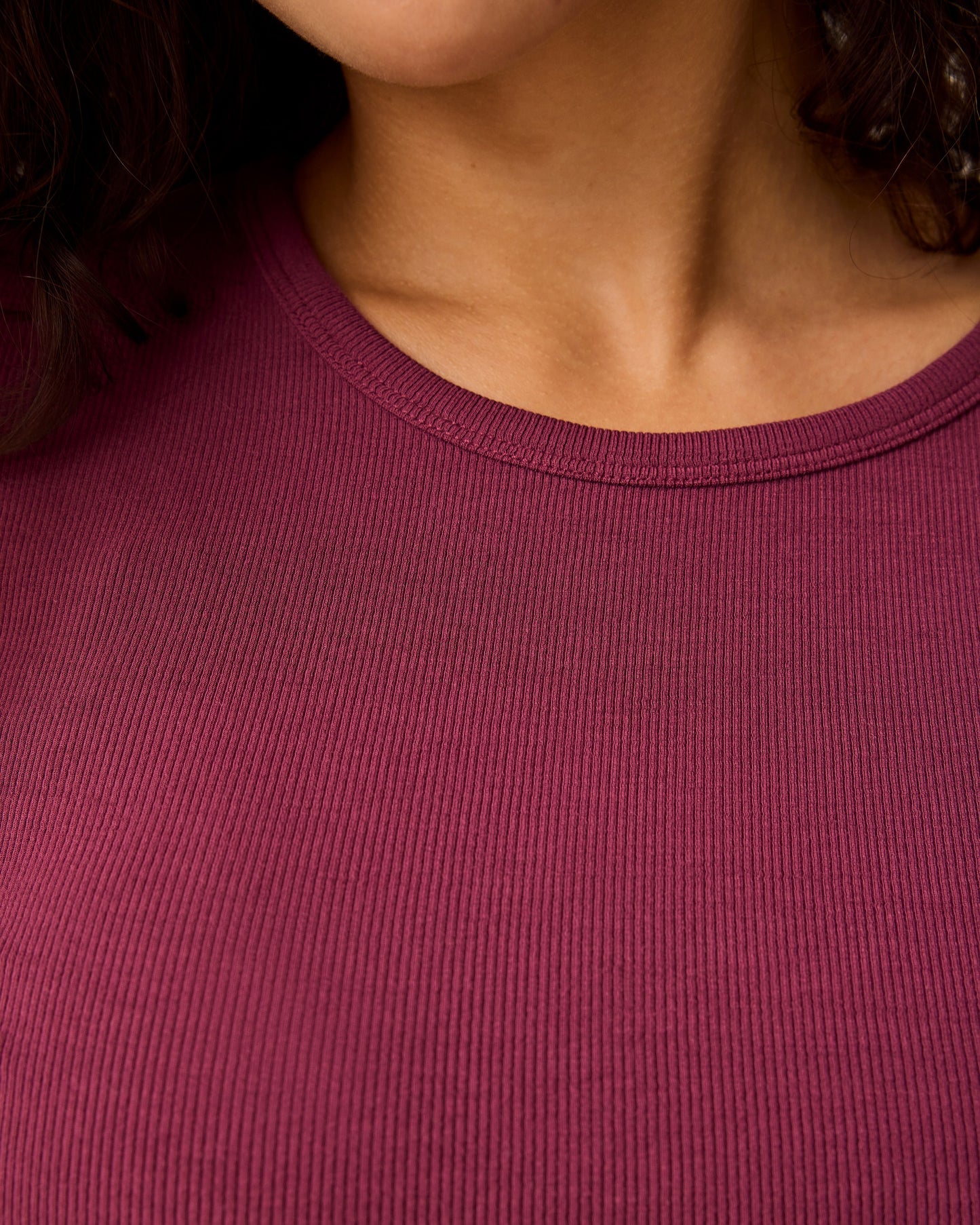 Close up of collar on Ribbed Bamboo Long Sleeve Nursing T-shirt in Deep Burgundy with black pants.