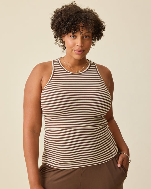 Model is wearing Ribbed Bamboo Racerback Nursing Tank in Chocolate & Ivory Stripe on a beige background. @model_info:Skye is wearing a Large.