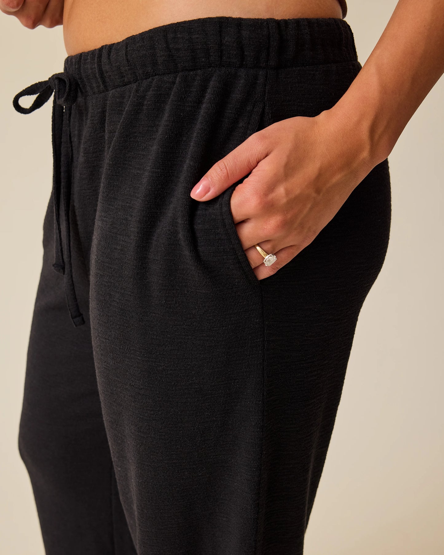 Woman wearing Luxe Terry Maternity & Postpartum Pant in Black, showing closeup of waistband and pocket