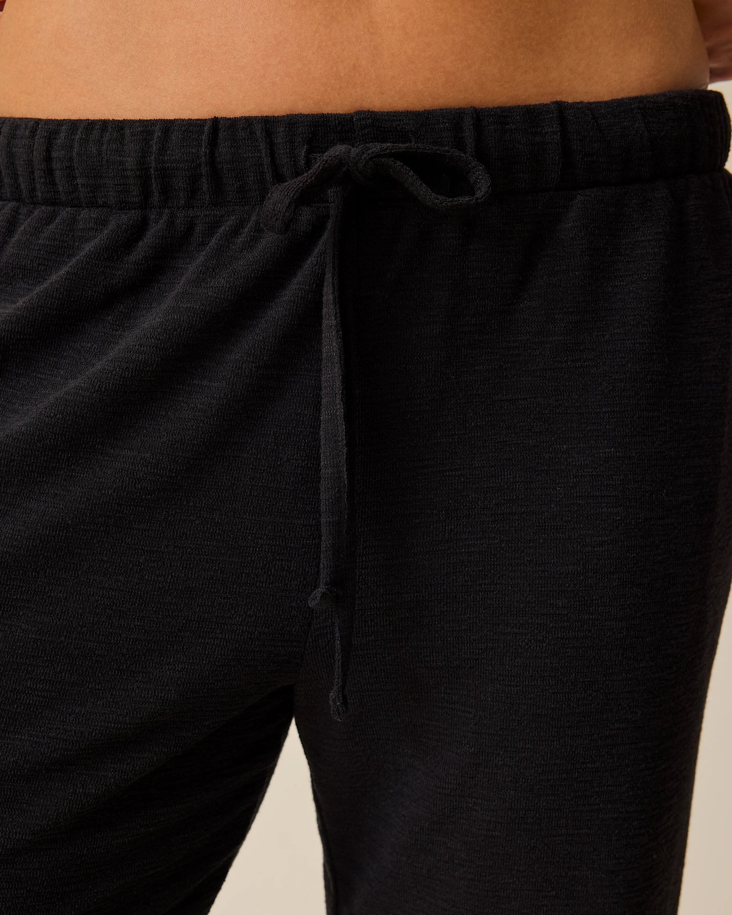 Woman wearing Luxe Terry Maternity & Postpartum Pant in Black, showing closeup of waistband and drawstring