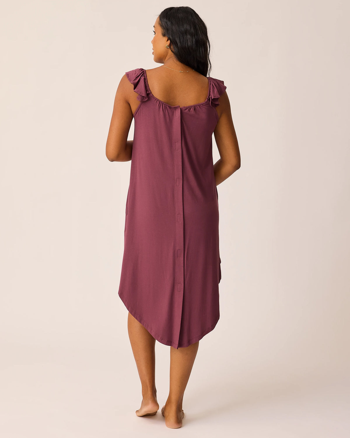 Woman wearing the Ruffle Labor & Delivery Gown in burgundy plum, showing back of gown