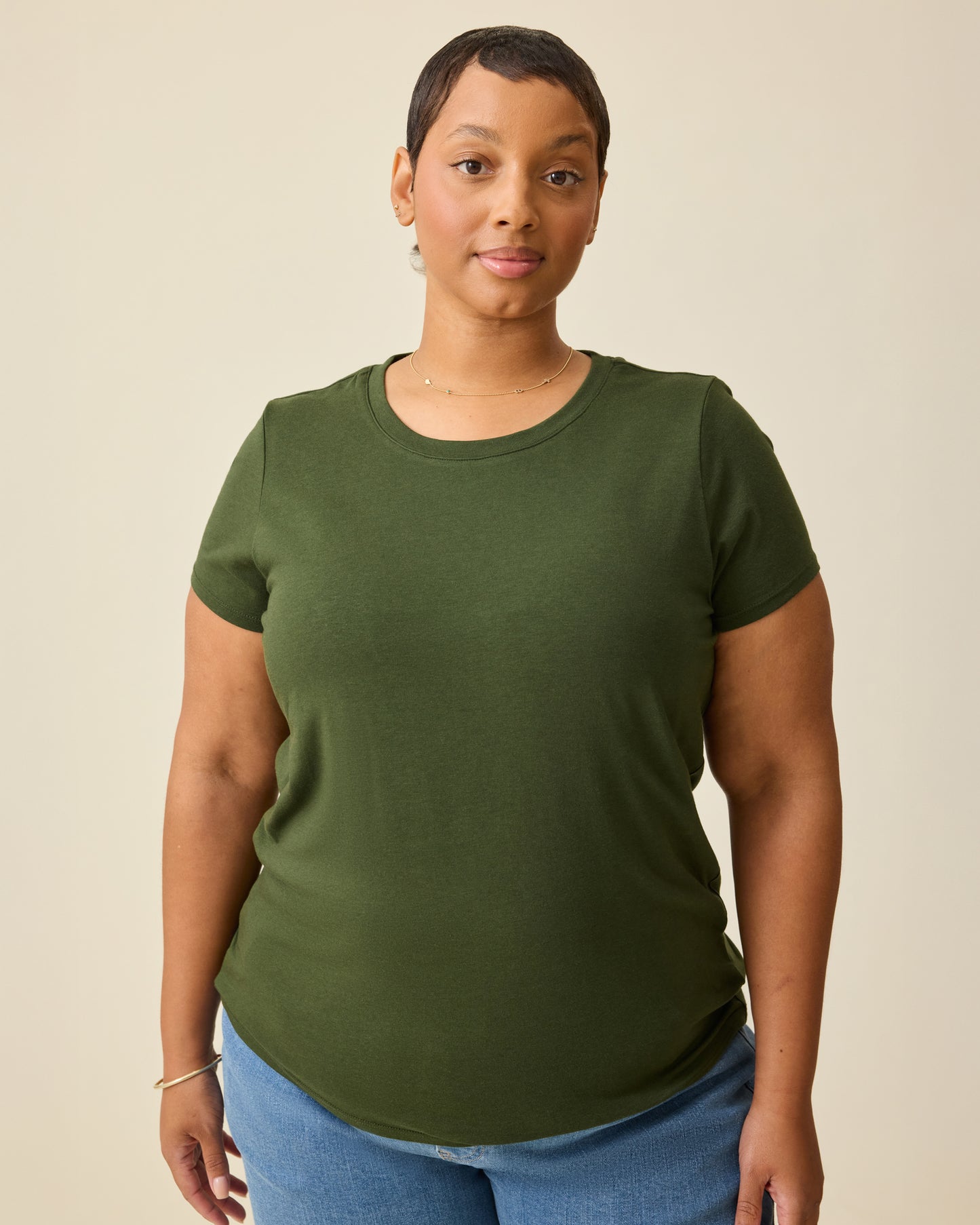 Model is wearing Modal Crew Neck Nursing T-shirt in Deep Olive, on a beige background.@model_info:Brittany is wearing an X-Large.
