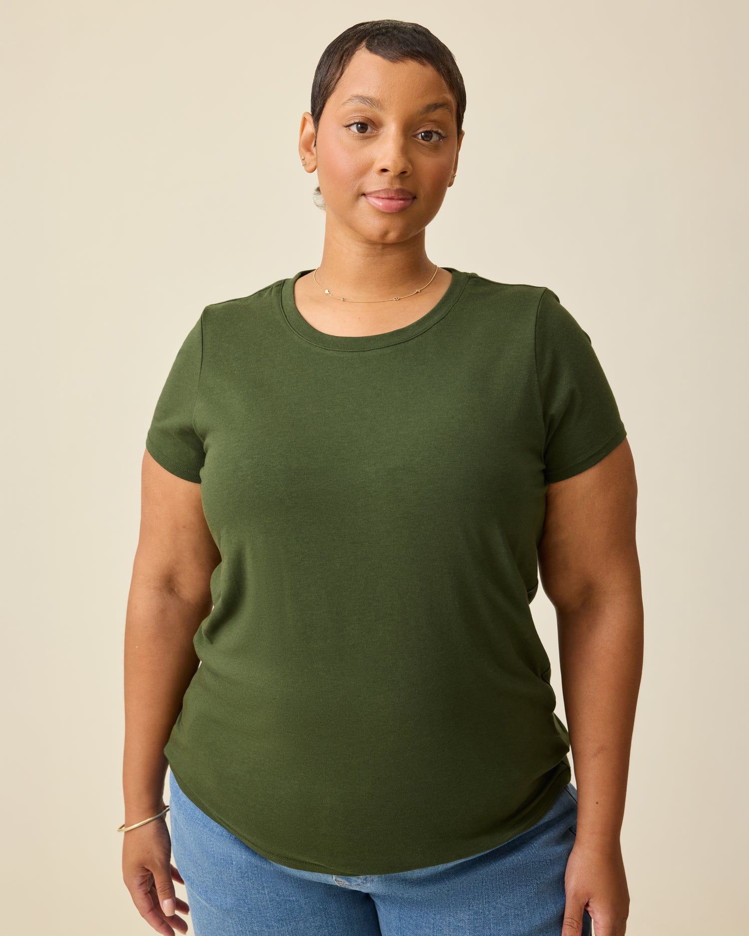 Model is wearing Modal Crew Neck Nursing T-shirt in Deep Olive, on a beige background.@model_info:Brittany is wearing an X-Large.