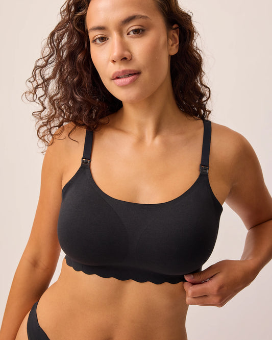 Model is wearing BareBond™ Cotton Maternity & Nursing Bralette in Black on a beige background.@model_info:Sadie is wearing a Medium.
