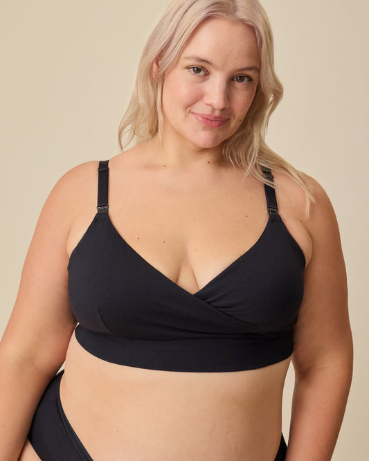 Model is wearing SoftStretch Cotton Nursing Bra and SoftStretch Cotton Maternity & Postpartum Hipster in Black on a beige background. 
@model_info:Allie is wearing an X-Large.