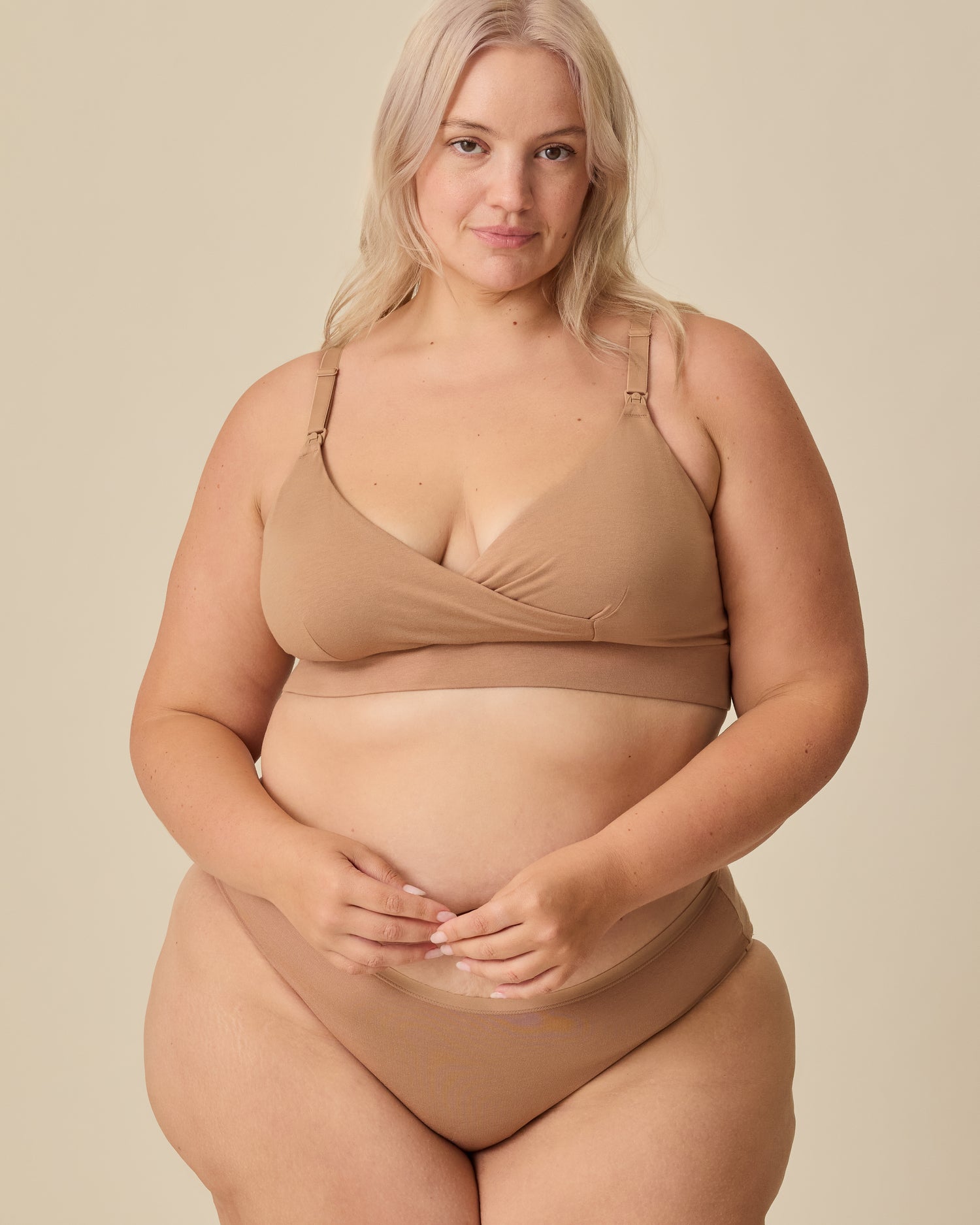 Model is wearing SoftStretch Cotton Nursing Bra in Buff and SoftStretch Cotton Maternity & Postpartum Brief in Buff on a beige background.