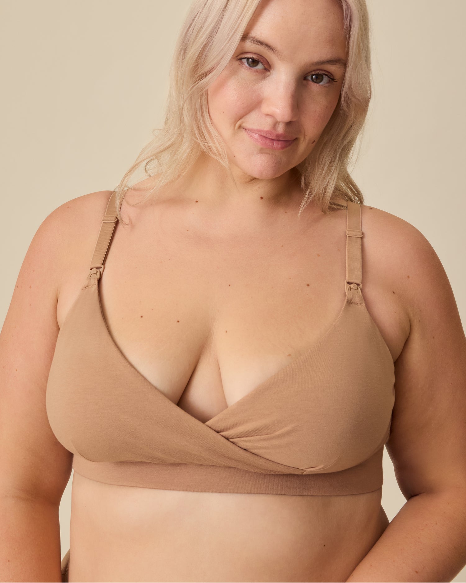 Model is wearing SoftStretch Cotton Nursing Bra in Buff on a beige background. @model_info:Allie is wearing an X-Large.