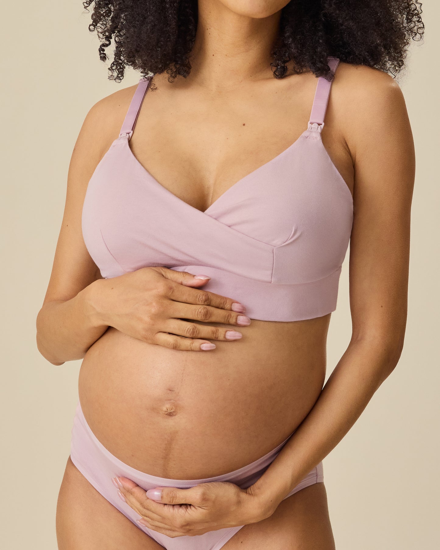 Pregnant model wearing SoftStretch Cotton Nursing Bra and SoftStretch Cotton Maternity & Postpartum Brief in Lilac Mist on a beige background.
