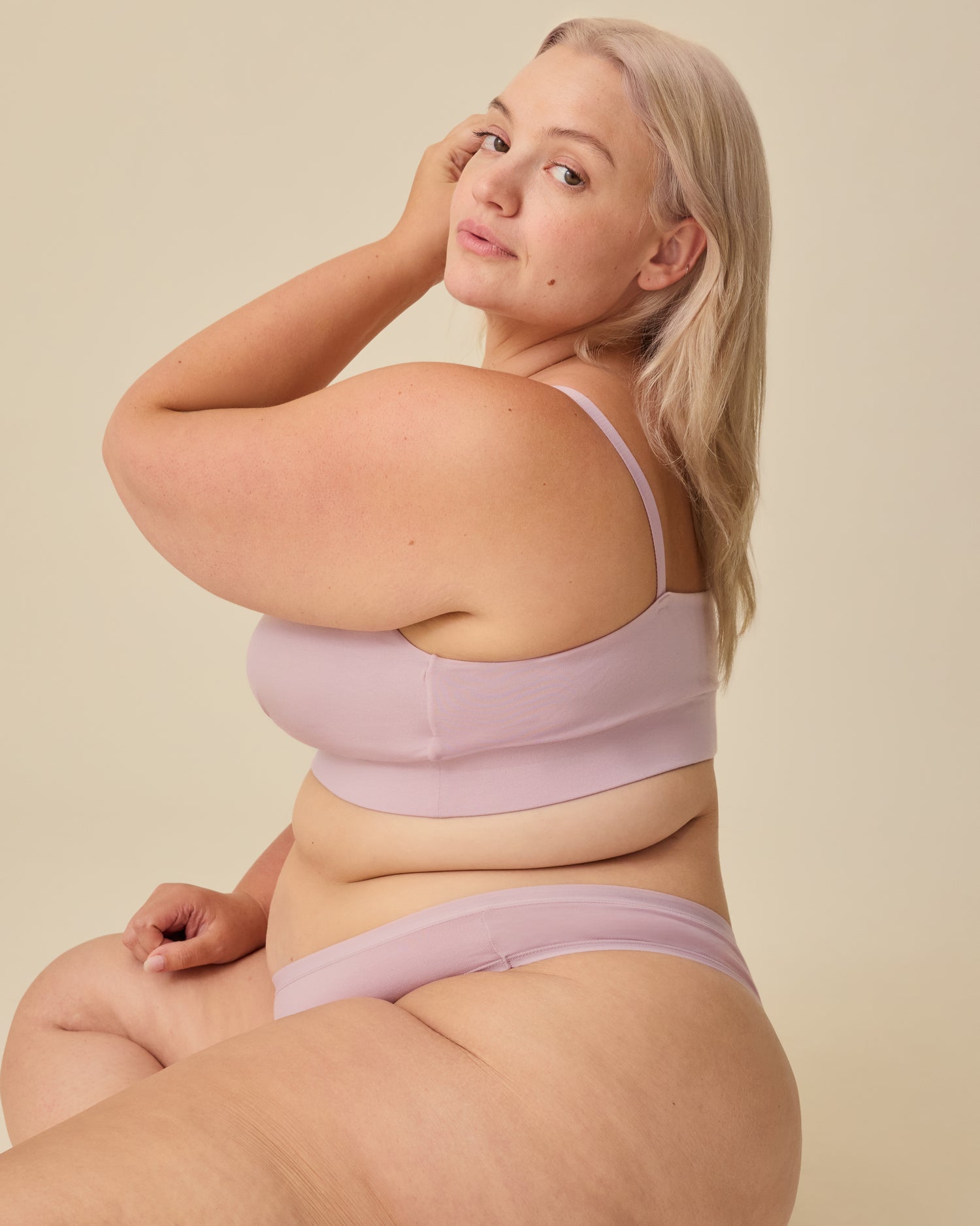 Side view of model wearing SoftStretch Cotton Nursing Bra in Lilac Mist and SoftStretch Cotton Maternity & Postpartum Thong in Lilac Mist on a beige background.