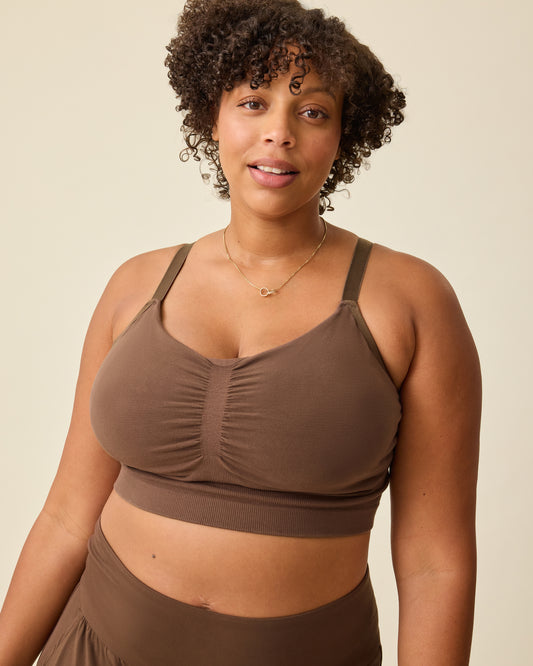 Model is wearing Sublime® Bamboo Hands-Free Pumping Lounge & Sleep Bra in Chocolate on a beige background. @model_info:Skye is wearing a Busty X-Large.